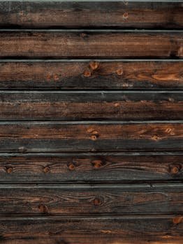 Close-up of a rustic wooden plank wall showing detailed grain and texture for interior design.